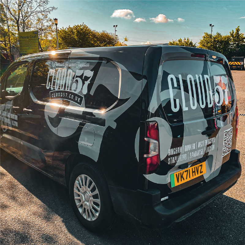 The back corner of a black van with a large 57 graphic on.